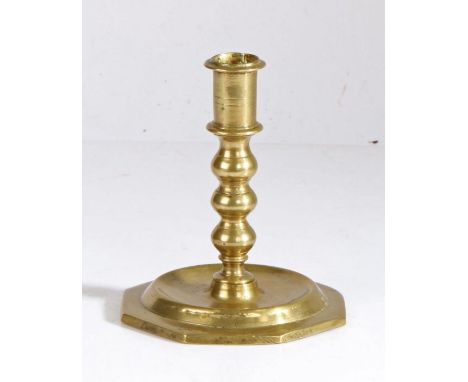 A late 17th century brass candlestick, circa 1680Having a straight-sided socket with narrow flange, a triple-ball stem and di