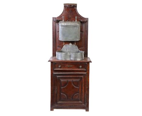 An 18th century chestnut buffet with pewter water cisternThe shaped and geometric-moulded backboard with three niche-shelves,