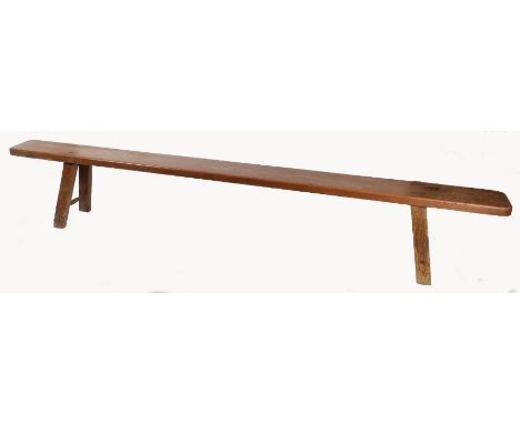 A Victorian pitch pine bench, circa 1840Having a deep and one-piece rounded rectangular top, with trestle-end supports tenone