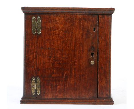 A small oak boarded mural cupboard, English, circa 1700Having a simple cornice, plain door and vacant interior, height 41.8cm