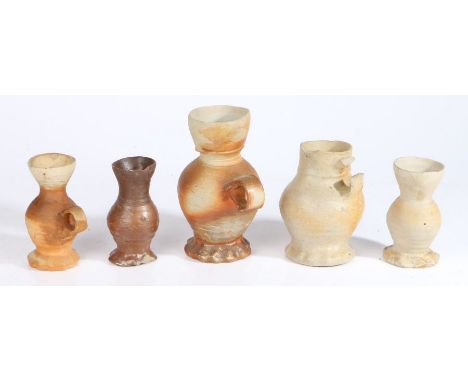A collection of 16th & 17th century potteryTo include jugs with flared lips and ribbed bodies, two cups of similar form and a