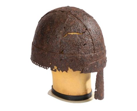 A Viking period 9th-10th century iron helmetMade of four arched panels and a crossed band, the edge with a perforated rim for