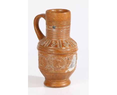 A Raeren late 16th/early 17th century stoneware jugWith a ribbed neck above portrait medallions, restored, 20cm high 