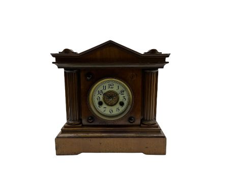 A light mahogany eight-day striking German mantle clock manufactured in the late 19th century by the Hamburg American Clock C
