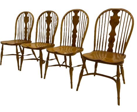 Set of four light elm stick back chairs, figured Windsor splat back, saddle seat, crinoline stretcher baseDimensions: Height: