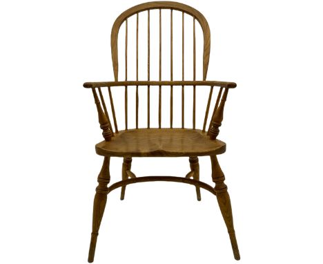 Georgian style light elm Windsor armchair, high comb back, saddle seat, crinoline stretcher baseDimensions: Height:&nbsp;106c