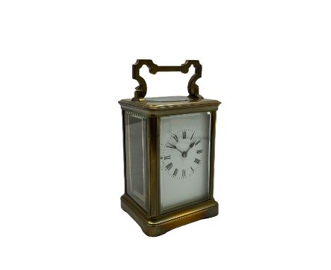 A late 19th century French timepiece carriage clock in a corniche case with a white enamel dial, Roman numerals and minute ma