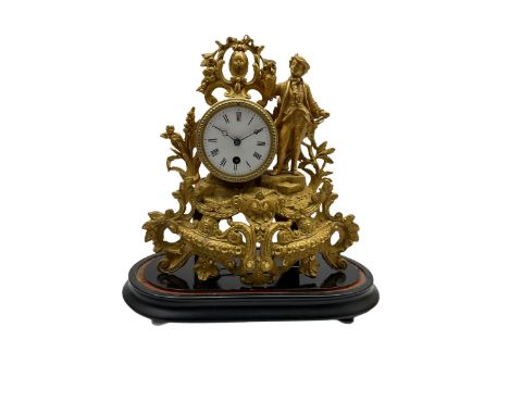 A late 19th century French 8-day timepiece mantle clock in a spelter case on an ebonised oval plinth, with a white enamel dia