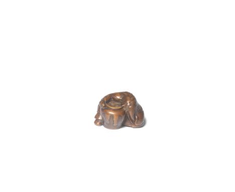 A WOOD NETSUKE OF A SHOJO (DRUNKEN SPRITE)Edo period (1615-1868), early/mid-19th centuryThe shojo slumped over with his arm s