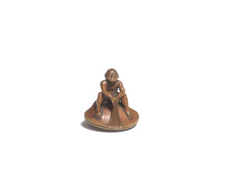 A WOOD NETSUKE OF A FISHERMAN ON A CLAMBy Kigyoku, Edo period (1615-1868), late 18th/early 19th centuryThe fisherman seated o