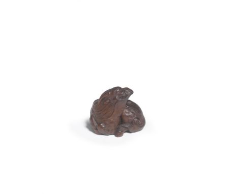 A WOOD NETSUKE OF A RECUMBENT KIRINBy Ikkan (1817-1893), Nagoya, Edo period (1615-1868) or Meiji era (1868-1912), 19th centur