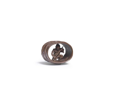 A WOOD NETSUKE OF A COOPER INSIDE A BARRELBy Morita Soko (1879-1942), Taisho (1912-1926) or Showa (1926-1989), 20th centuryTh