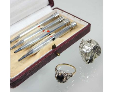A ladies cabochon cluster ring, unmarked, size M, together with a pendant in the from of an elephant and a set of four silver