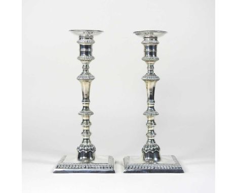 A pair of George III silver table candlesticks, each with a removable sconce and knopped stem, on a weighted square base, by 