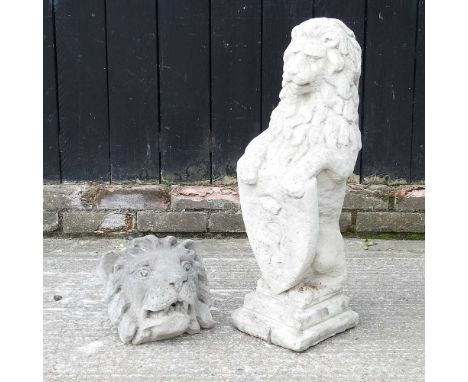 A cast stone model of a lion with shield, 82cm high, together with a lion mask (2)