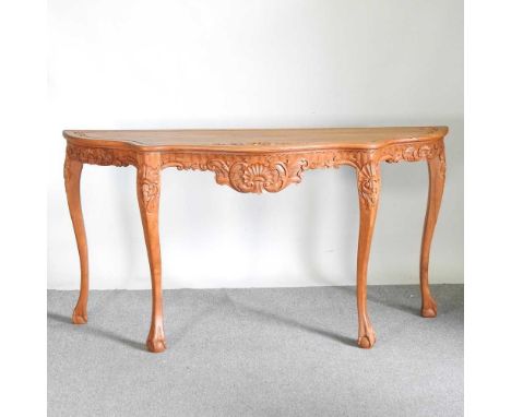 A large Indonesian carved hardwood console table, of serpentine form, on cabriole legs190w x 49d x 100h cm