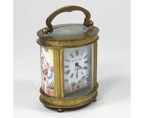 A continental brass cased miniature carriage clock, of oval shape, with a painted dial, 9cm high