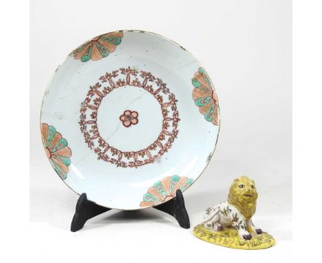 An 18th century Japanese porcelain dish, with scrolled decoration, 21cm diameter, together with a 19th century French faience
