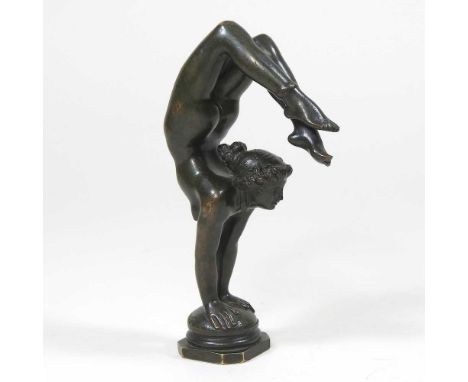 A verdigris bronze figural desk seal, modelled as an Art Nouveau acrobatic lady, signed indistinctly to the base, 14cm highOv