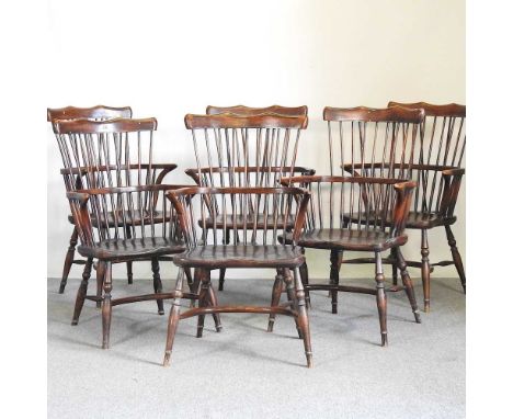 A set of six windsor style West Country comb back elbow chairs, 20th century, each on turned legs, with a crinoline stretcher