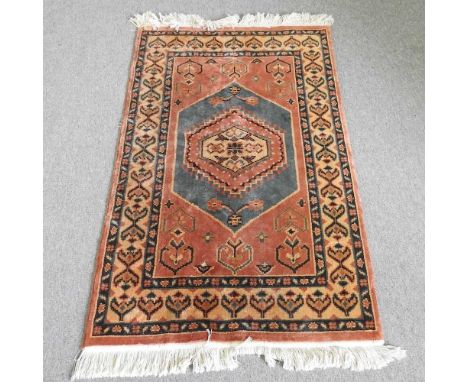 A Turkish carpet, with a central medallion, within multiple borders, 150 x 91cm