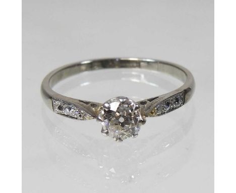 An 18 carat gold diamond ring, approximately 0.65 carats, with diamond shoulders, 2.6g, size SOverall condition is complete a