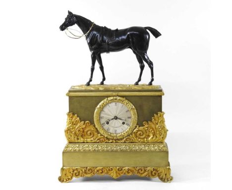 A 19th century French gilt and ormolu mantel clock, surmounted by a bronze model of a horse, the ornate acanthus scrolled cas