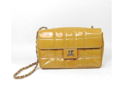 A Chanel Choco Bar clutch bag, in caramel patent leather, with gilt chain strap, certificate no. 7441271, 26cm wide, with aut