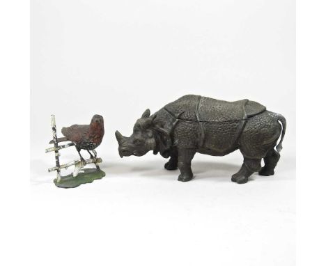 A 19th century novelty inkwell, in the form of a rhinoceros, with a hinged lid, 22cm long, together with a painted metal mode