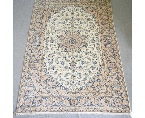 A Persian Kashan carpet, with all over floral designs on a cream ground, 313 x 202cm
