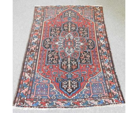 A Persian carpet, with a central flowerhead medallion, 200 x 130cm