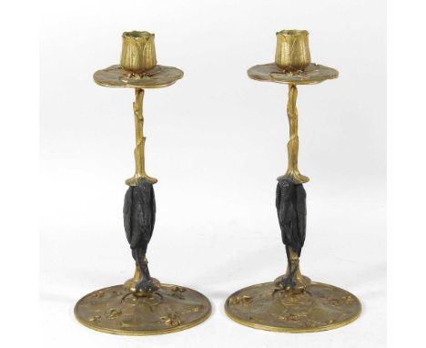 Manner of Antoine-Louise Barye, 1795-1875, a pair of gilt bronze table candlesticks, each of Art Nouveau design, with a stork