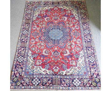 An Isfahan carpet, with a large red central medallion, 348 x 248cm