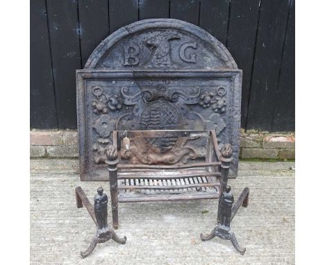 A large cast iron fire back, of arched shape, decorated in relief with a heraldic crest and inscribed BG, 86 x 87cm, together