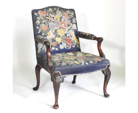 A George III carved mahogany open armchair, possibly Irish, of generous proportions, with a later tapestry back and seat, wit