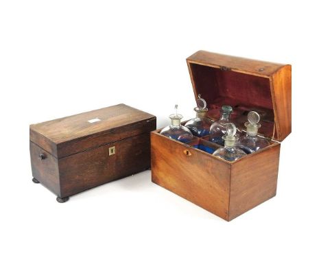 A George III mahogany decanter box, with a curved hinged lid, containing five glass decanters, 28cm wide, together with a lat