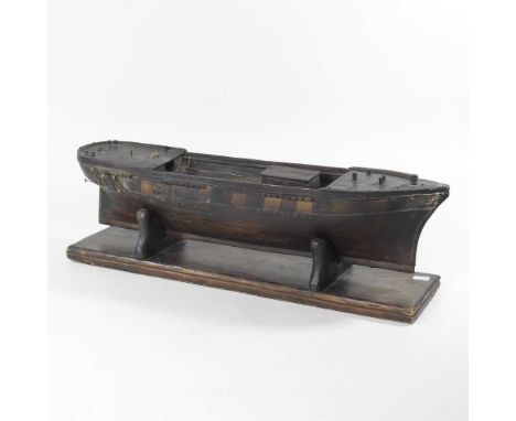 A wooden scale model of a 19th century ship's hull, on stand, 54cm longOverall condition looks to be complete, but dirty and 