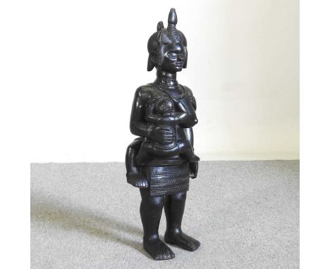 A large African carved hardwood figure, of a mother standing holding a child, 76cm highOverall condition looks to be complete