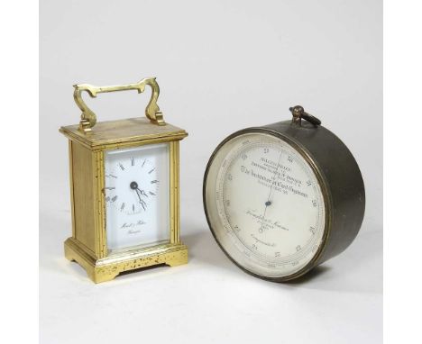 A brass cased carriage clock, 11cm high, together with a late 19th century compensated aneroid barometer, the silvered dial s