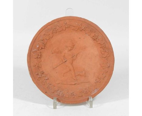 A 19th century terracotta plate, decorated in relief with a cherub, within a vine border, signed Anne Knight 1840, 16cm diame