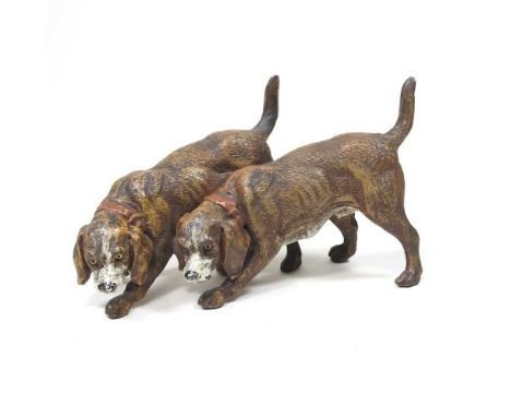 A 19th century painted metal model of two hounds, 14cm long