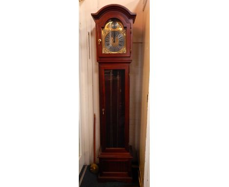 An Interclock mahogany cased longcase clock, brass broken arch dial with brushed steel chapter ring bearing Roman numerals, t