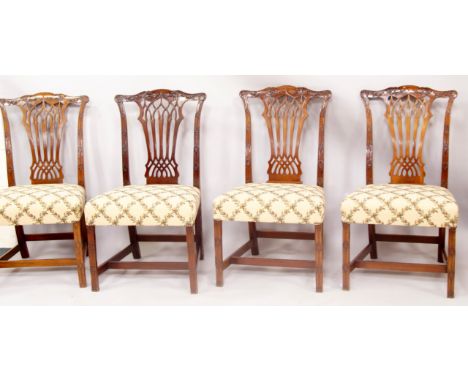 A set of four Chippendale design dining chairs, each with carved cresting rail, Gothic type splat and Chinese tracery carving