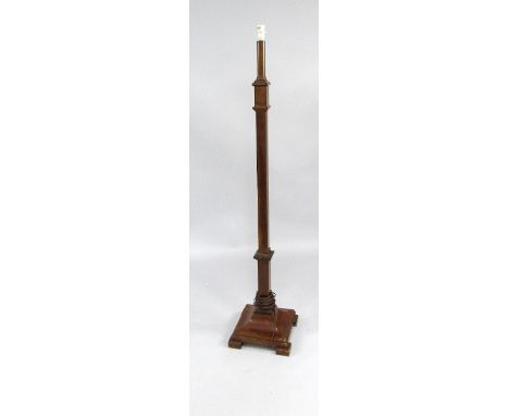 A 1930s mahogany standard lamp, with square section column and tapered square base on block feet.