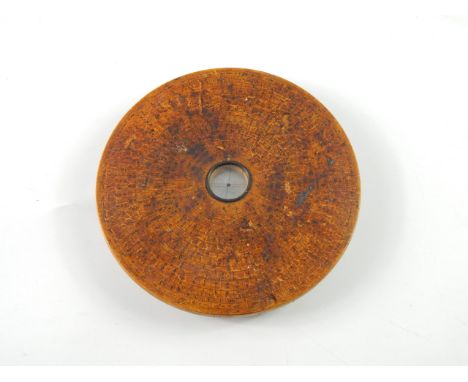 A Chinese calibrated geomancer's compass, wooden circular casing with ink markings, signed verso, 16.5cm diameter.