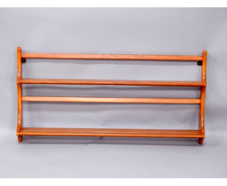 An Ercol retro style light elm wall shelf or plate rack, 97cm wide