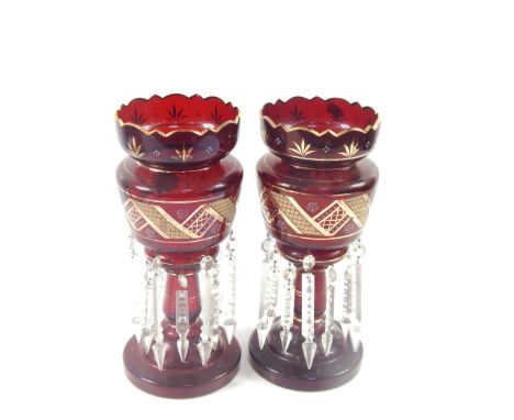A pair of ruby glass lustres, late 19thC, gilt and enamel decorated with clear glass prismatic drops, 35.5cm high.