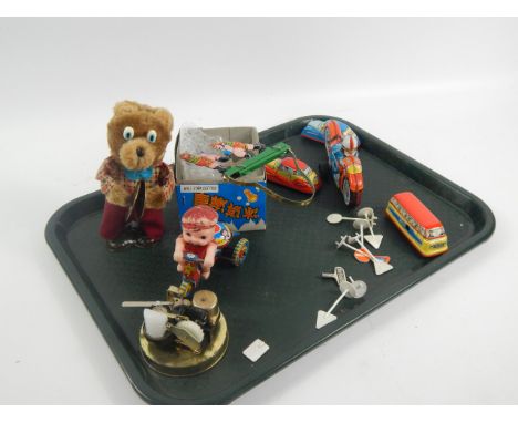Various tin plate toys, to include a Japanese child on a tricycle, a Chinese bear playing cymbals, a mechanism from a Japanes
