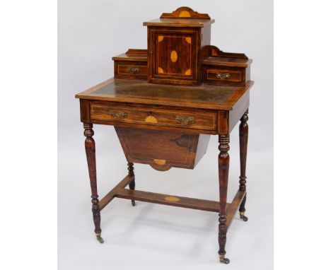 A Victorian lady's rosewood and satinwood inlaid sewing cum writing table, the breakfront top with an arrangement of drawers 