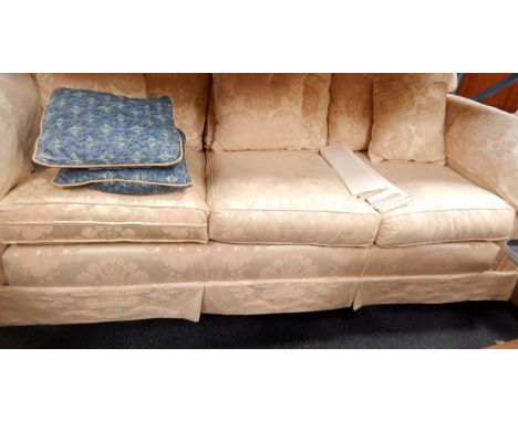 A Rousseau three seater sofa, upholstered in patterned ivory damask, 220cm x 92cm x 92cm.